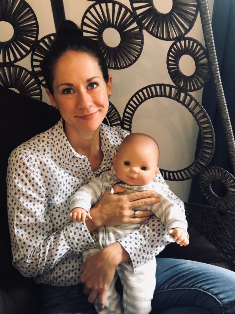 Marina im Babymassagekurs mit der Massagepuppe